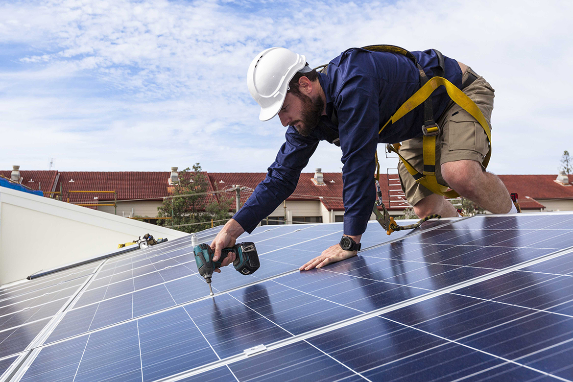 A Professional Electrician Working on Solar Panels