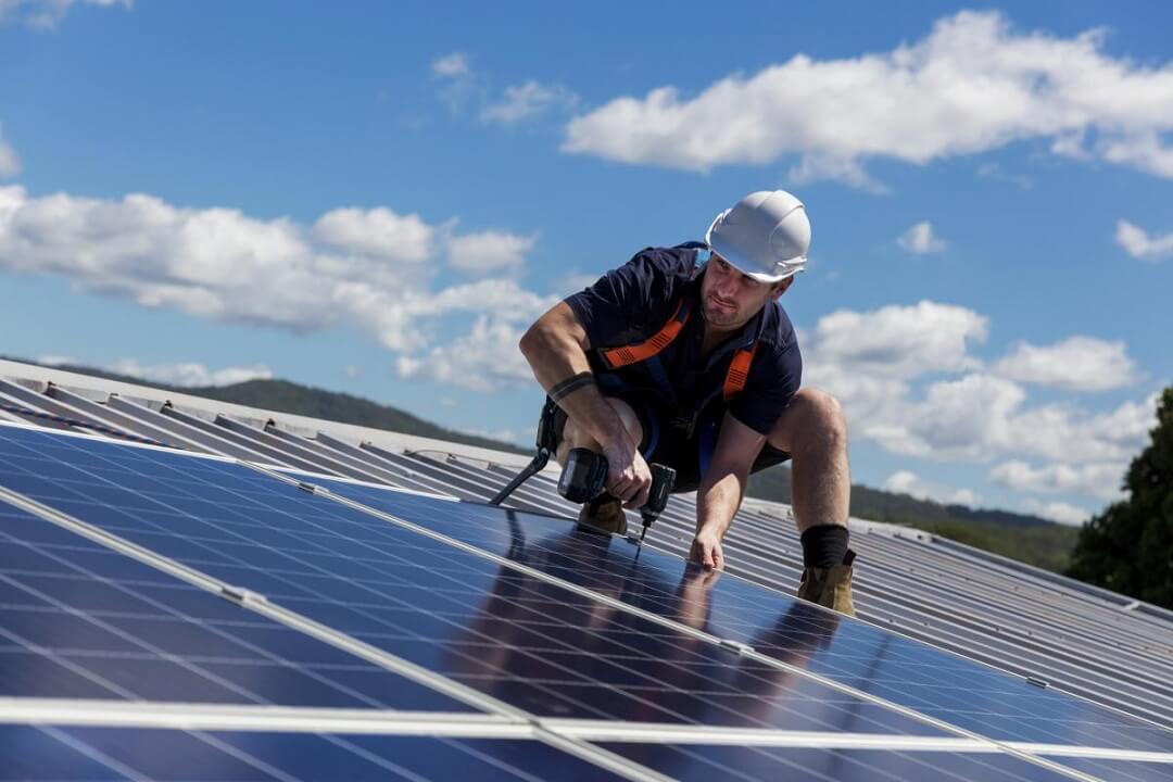 A Man Working on Solar Panels